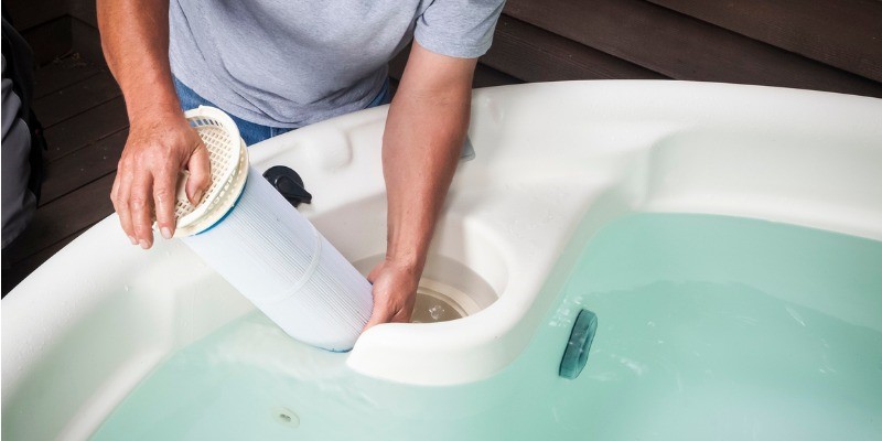 Man cleaning hot tub filter